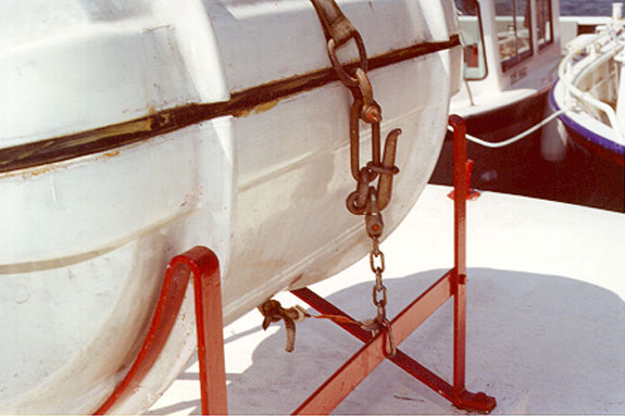 Photo 13 - Manual release Senhouse slip securing inflatable liferaft in cradle on superstructure top